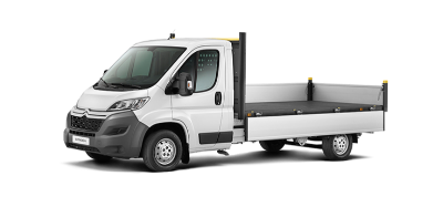 White flatbed truck viewed from the side.