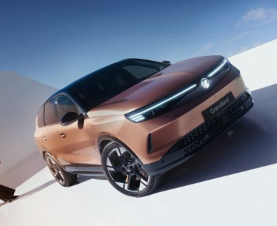 Copper-coloured SUV with a sleek design and distinctive grille, viewed from the front side.