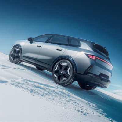 Silver SUV parked on snow, viewed from the rear right side.