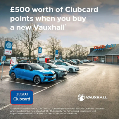 £500 Clubcard points offer with new Vauxhall purchase displayed outside a Tesco Extra store.