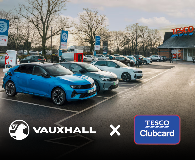 Vauxhall electric vehicles charging at Tesco with logos of Vauxhall and Tesco Clubcard.